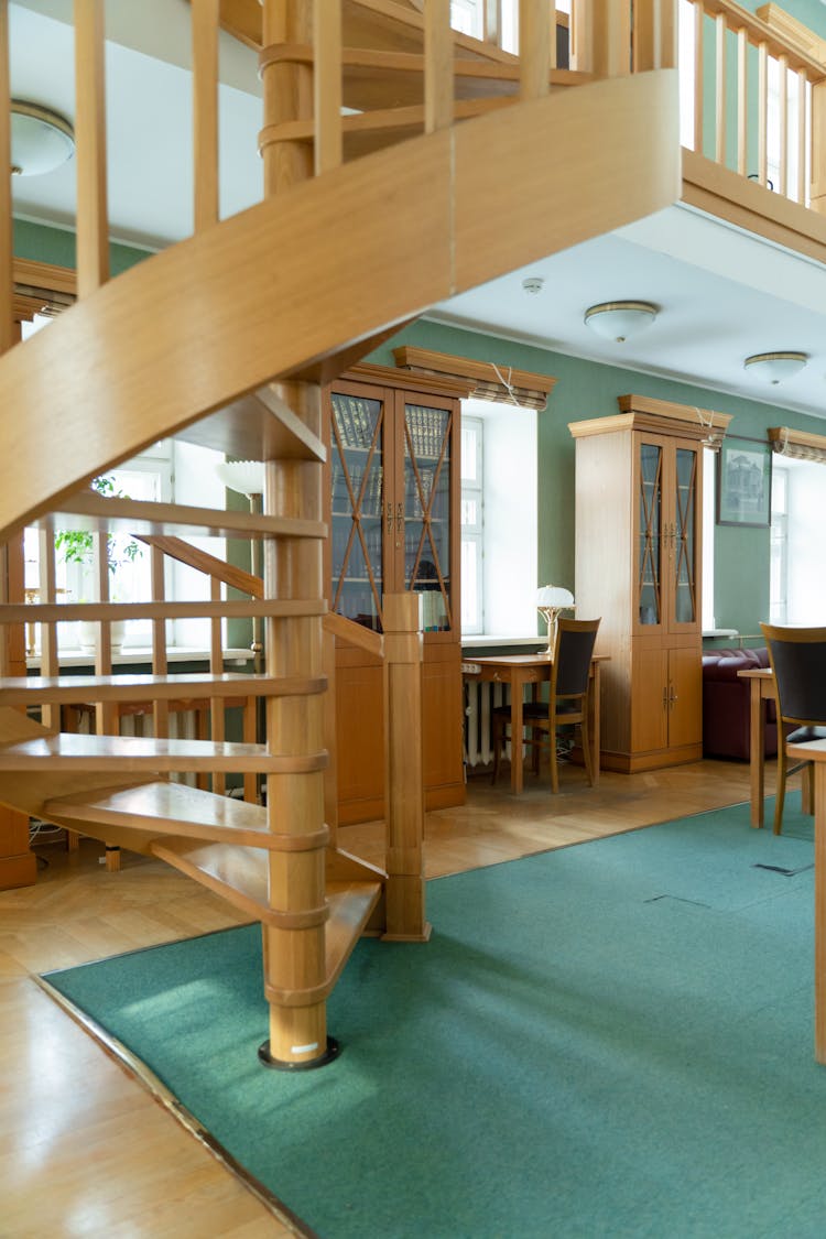 Brown Wooden Spiral Staircase In Room