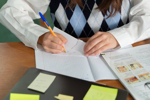 Woman Writing on White Paper 