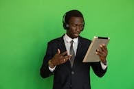 Man in Black Suit Holding Ipad