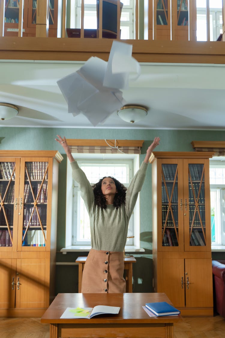 Woman Catching Falling Papers