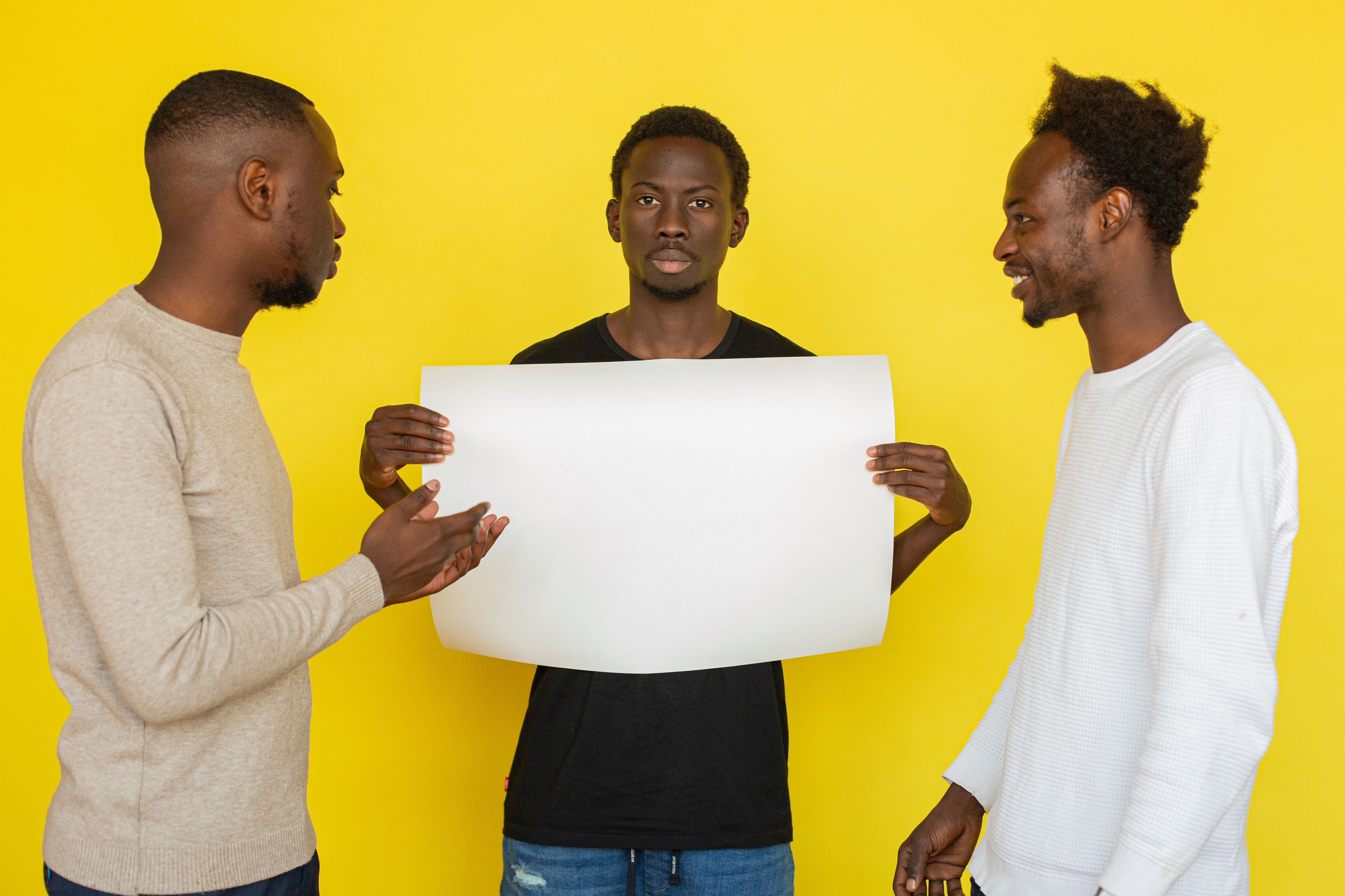 person standing calmly while others around them are arguing or looking skeptical