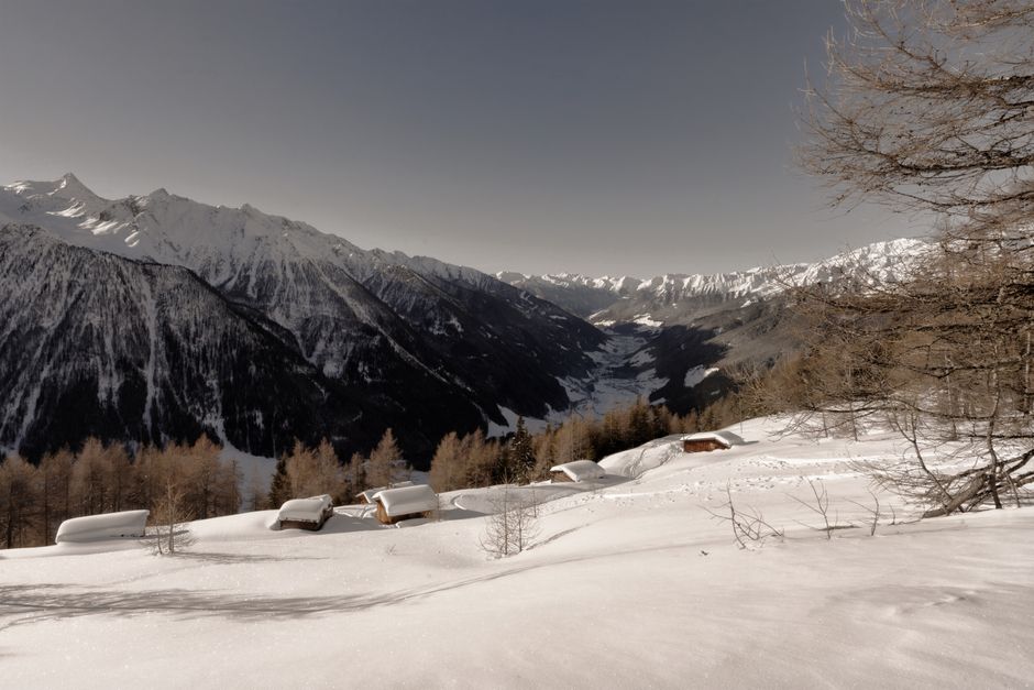 mountain cabin in snowy landscape with hiking trail