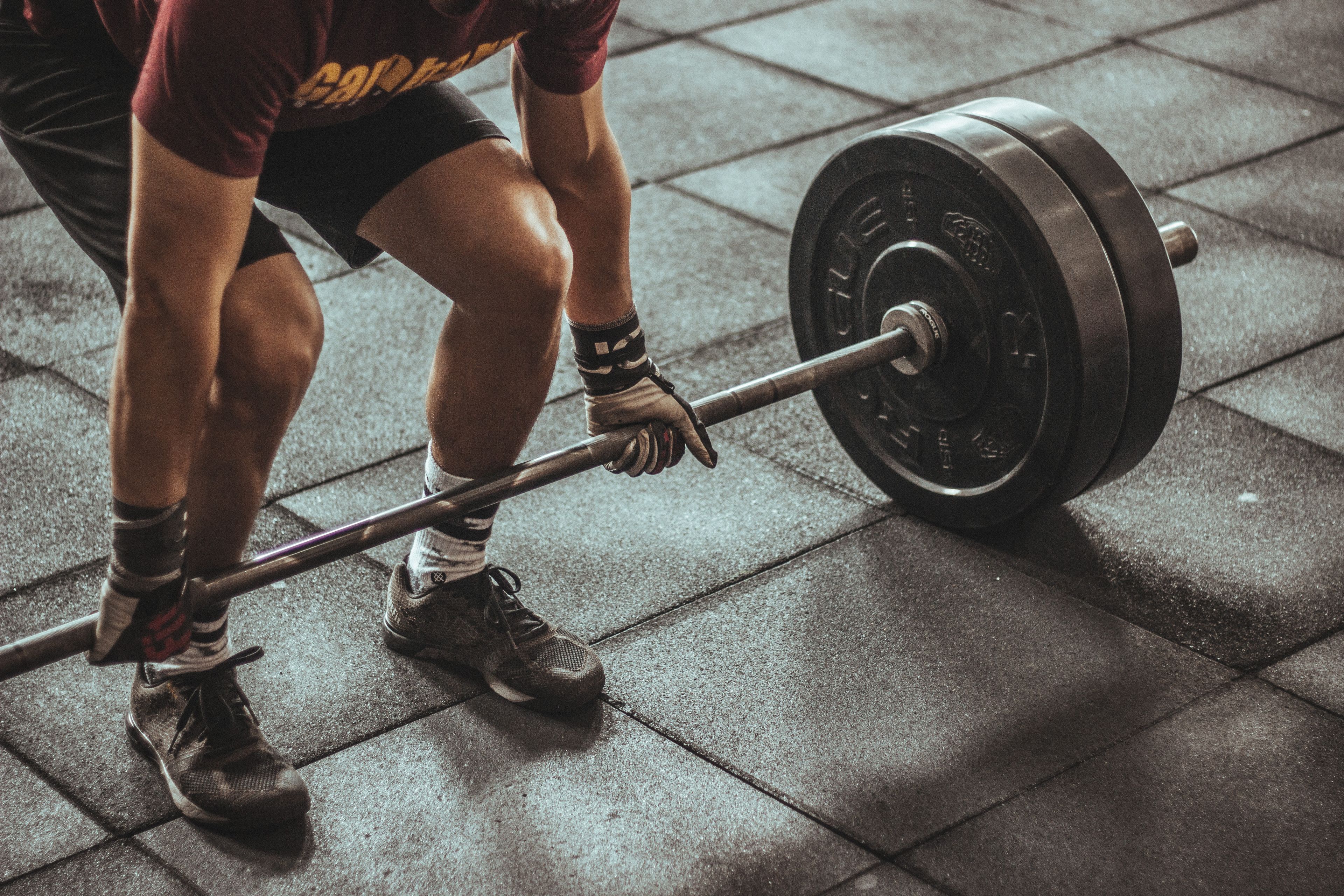 Trainer demonstrating a barbell lift