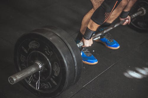 Free Close-up of a Person's Lower Body Holding Barbell Stock Photo
