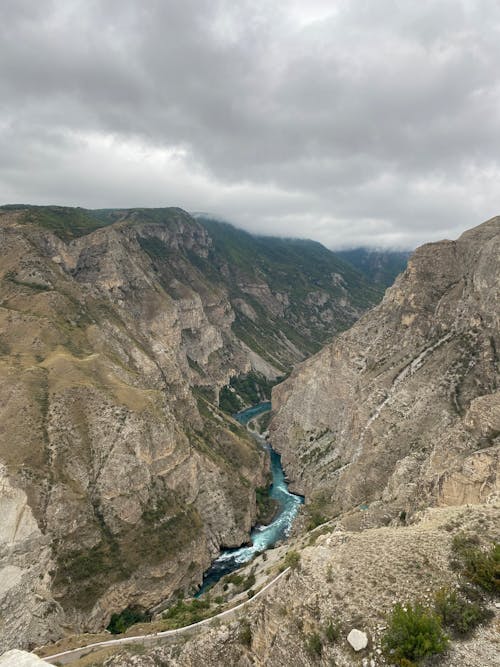 Clouds over River among Rocks