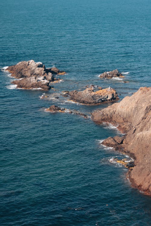 An Aerial Shot of Big Rocks on a Shore
