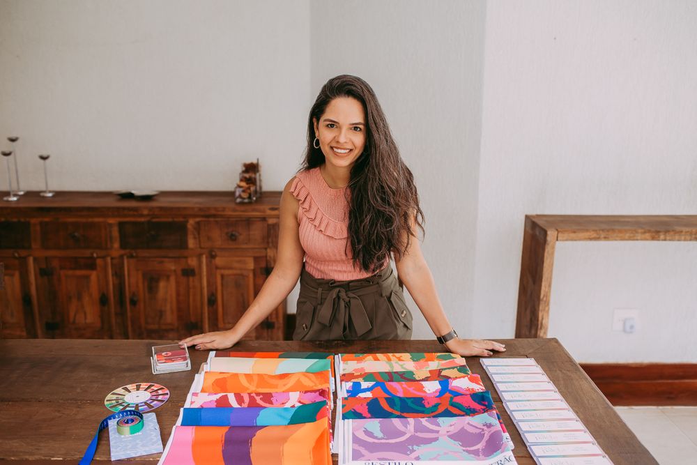 A designer at a table covered in fabric samples