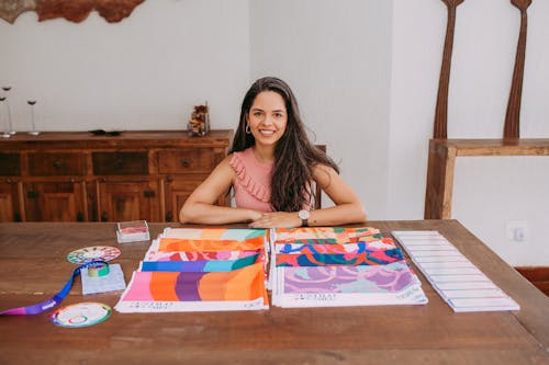 Woman Sitting at the Table with Fabric Samples 