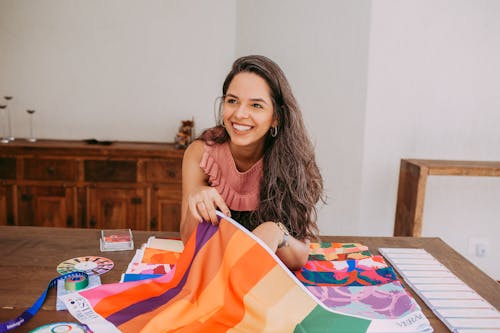 A Woman Holding a Multicolored Textile