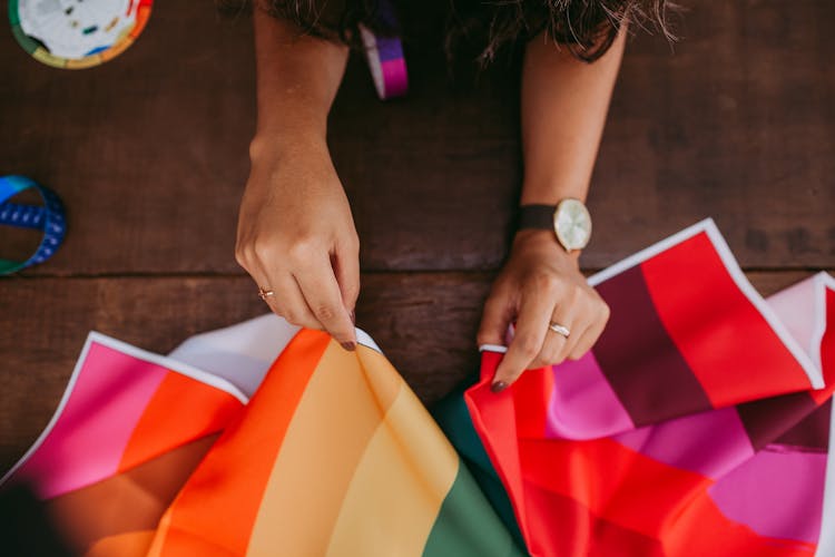 A Woman Holding A Multicolored Tarpaulin