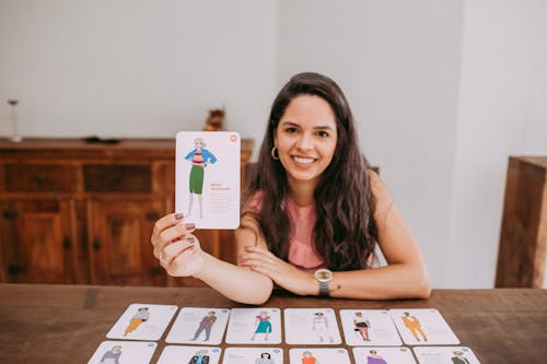 A Woman Holding a Fashion Advancement Card