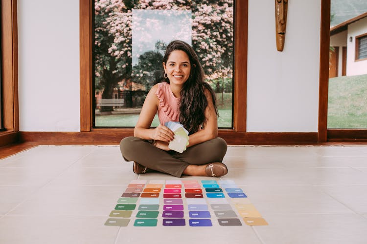 Woman Sitting On The Floor With Color Samples 