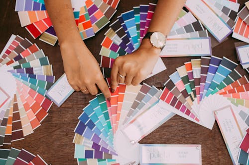 Woman Hands and Colorful Fabric Samples