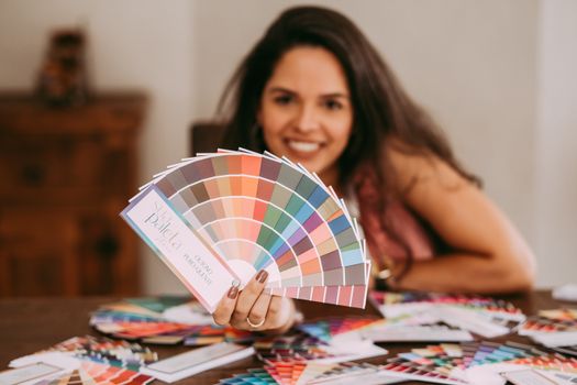 Smiling woman showcasing a vibrant color palette, perfect for creative inspiration.. smiling, woman, showcasing