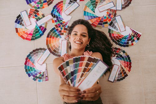 Woman Posing with Colorful Papers