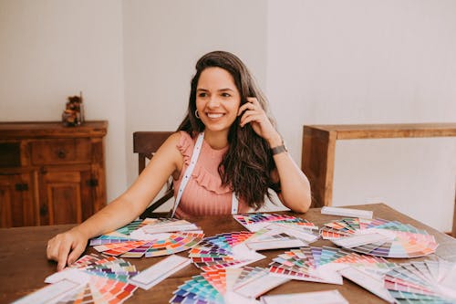 Smiling Woman Sitting with Color Wheels