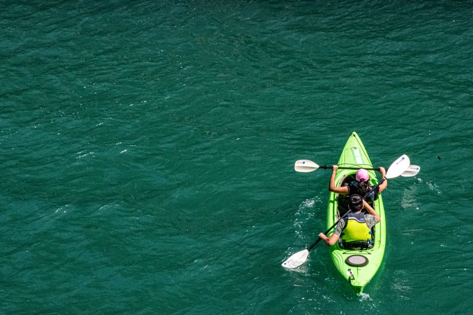 Intracoastal Adventures – Intro to Kayaking 2 High angle shot of two people kayaking in clear turquoise water, embracing nature. | BocaVibe
