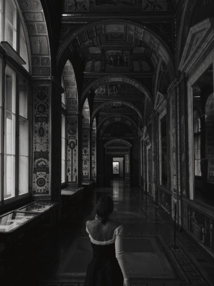 Woman Walking In Ornate Corridor