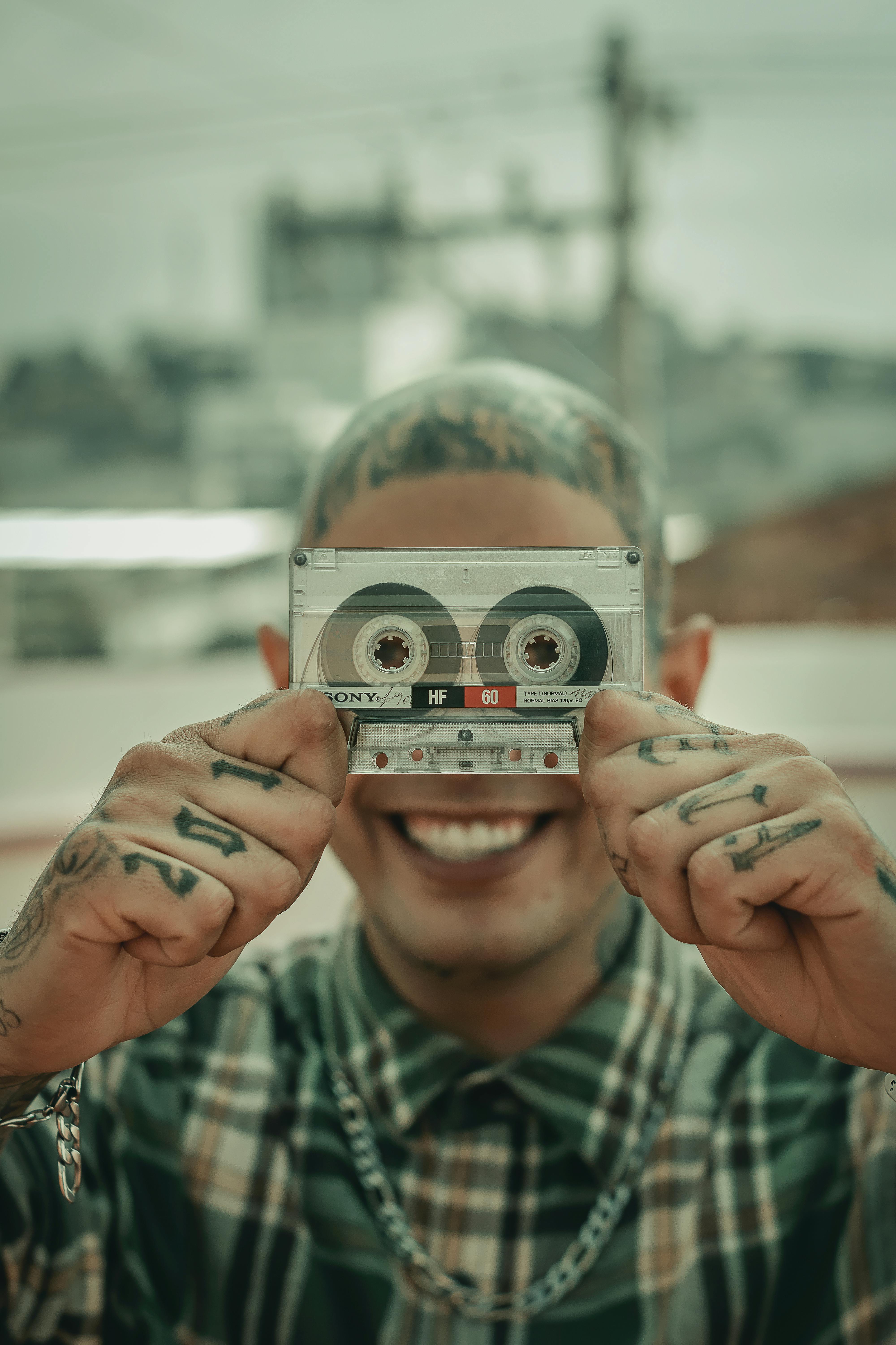 Man in Green and White Plaid Button Up Shirt Holding Gray and Black  Cassette Tape · Free Stock Photo, image size:4000x6000