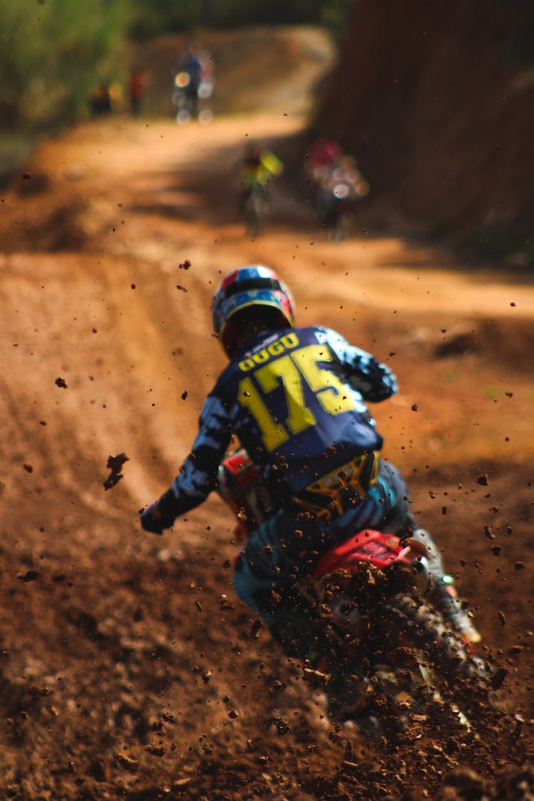 Mud Splashing Behind A Person Riding A Dirt Bike