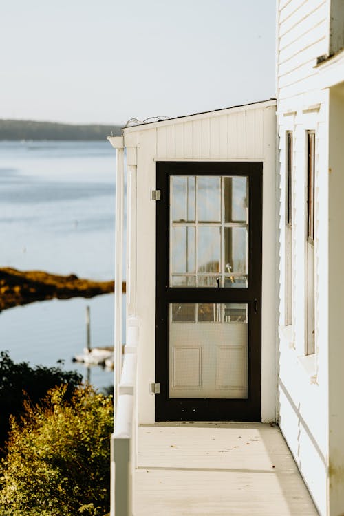 White Wooden House with Wooden Framed Glass Door 