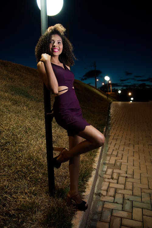 Free Woman Wearing Purple Dress Behind Gray Pole Photo Stock Photo