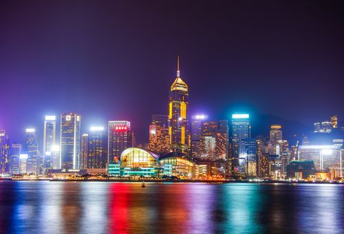 Free Dazzling nighttime view of Hong Kong's illuminated skyline with colorful reflections on Victoria Harbour. Stock Photo