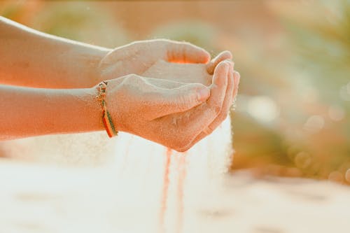 Hands Cupping the Sand 