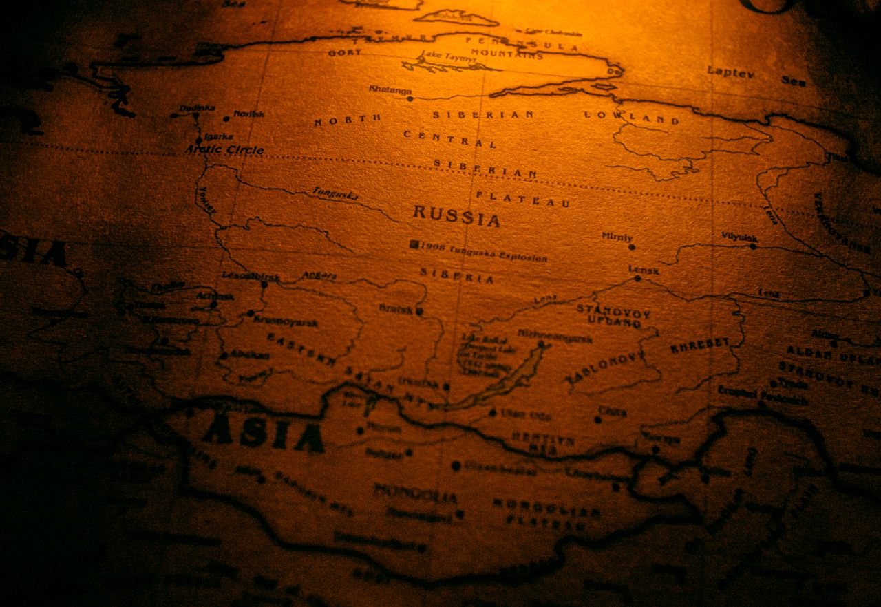 Close-up of an antiqued map highlighting Russia in a warm sepia tone.