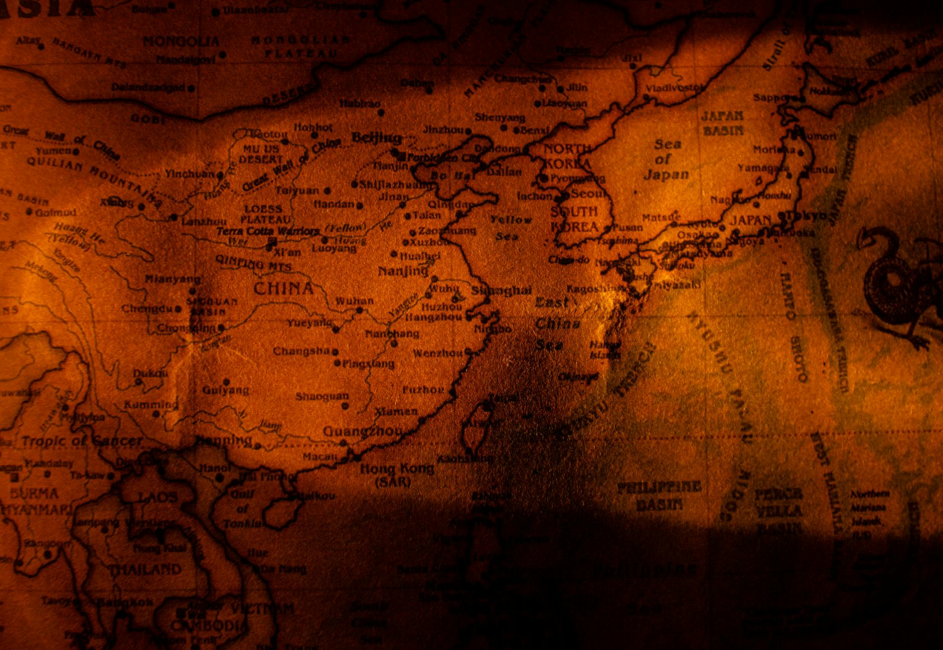 A close-up vintage map showing East Asia with sepia tones, highlighting China, Japan, and Korea.