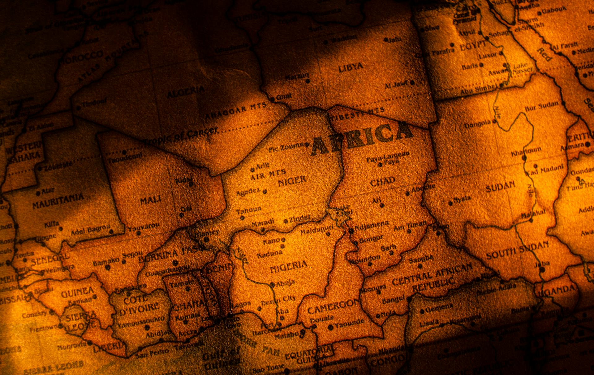 Close-up photograph of a vintage styled map highlighting Africa with brown sepia tones.