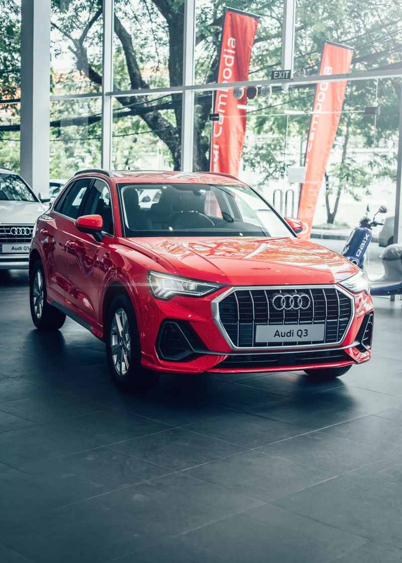 Bright red SUV displayed in a modern car showroom