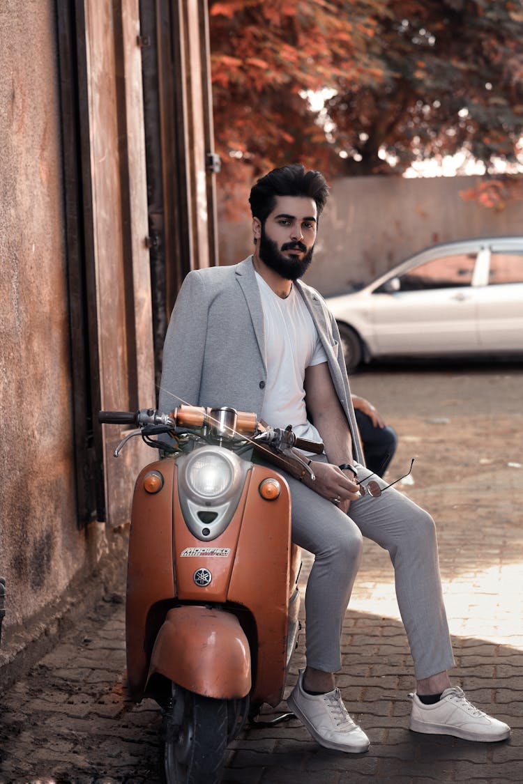 A Bearded Man Sitting On A Motorcycle