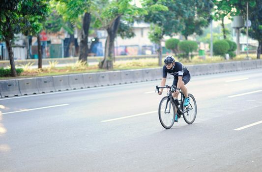 A Man Cycling in a City