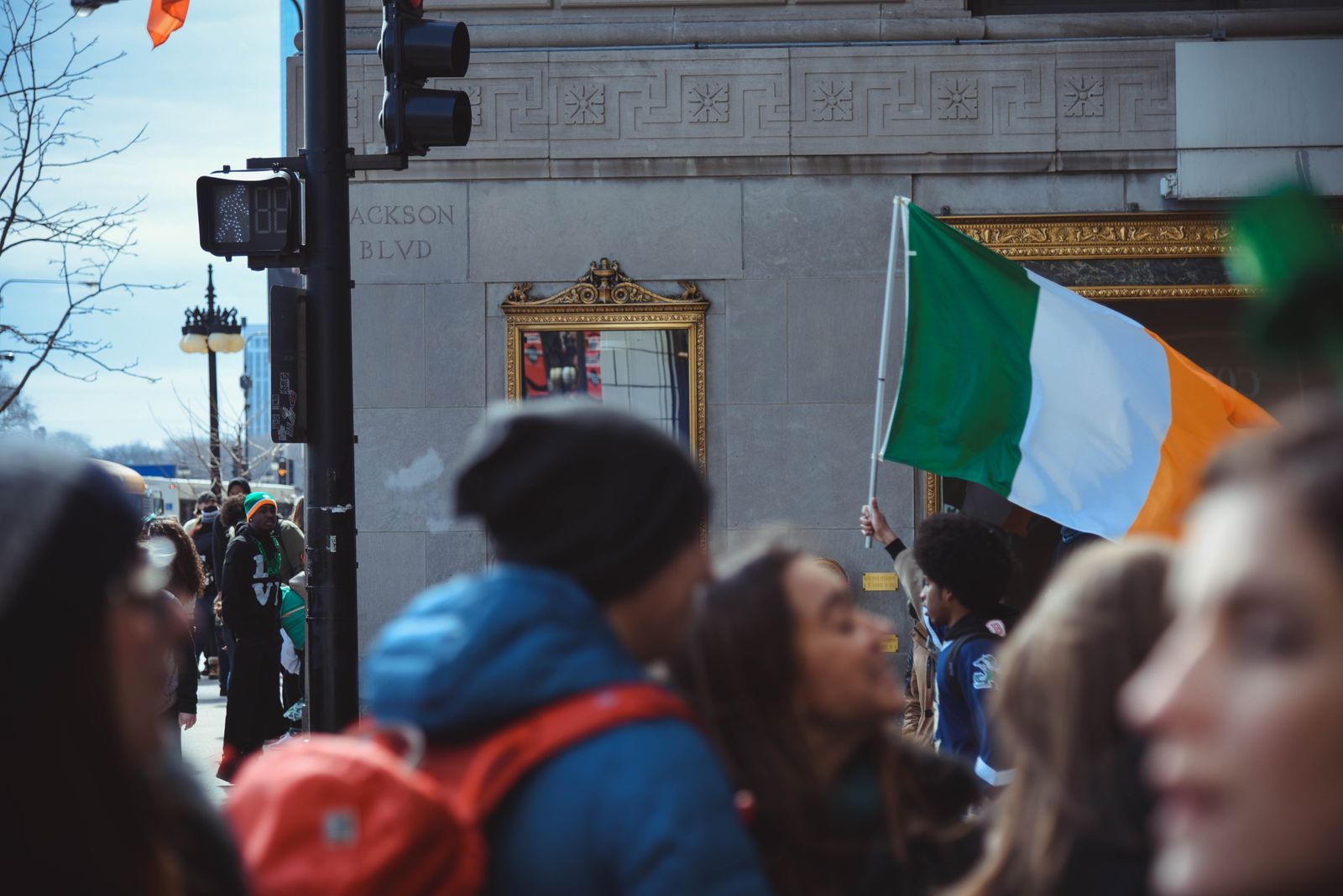 Crowd celebrates St. Patrick's Day in Chicago with Irish flags and festive atmosphere