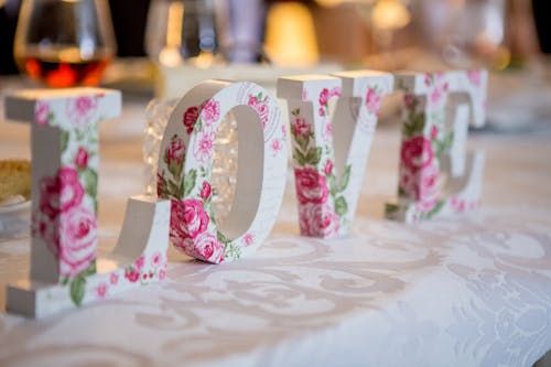 Decoration in love shaped form on table with food and wine glasses during celebration