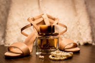 Brown Glass Fragrance Bottle Beside White Pearl Bracelets