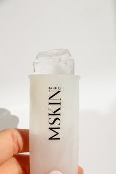 Close-up of a skin care ice roller designed for cryotherapy treatments with a sleek white background.