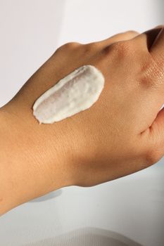 Close-up of a hand with cream applied, ideal for skincare and moisturizer concepts.