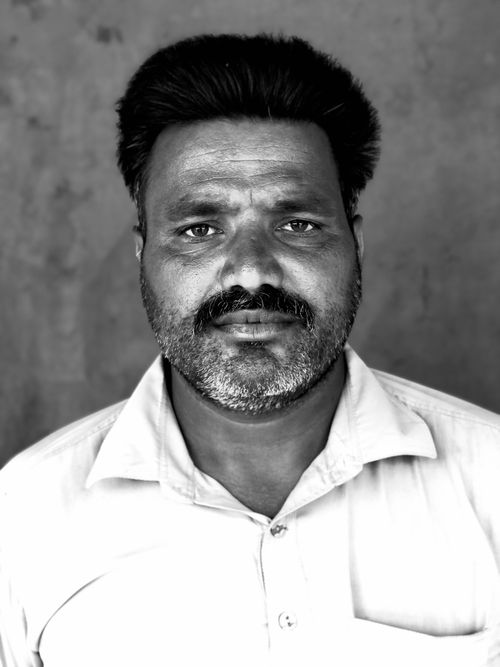 Free Grayscale close-up portrait of a bearded man in Minchinabad, exuding intensity and depth. Stock Photo