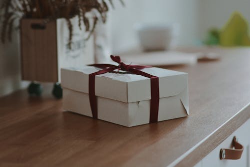 Free A Gift on a Wooden Surface  Stock Photo