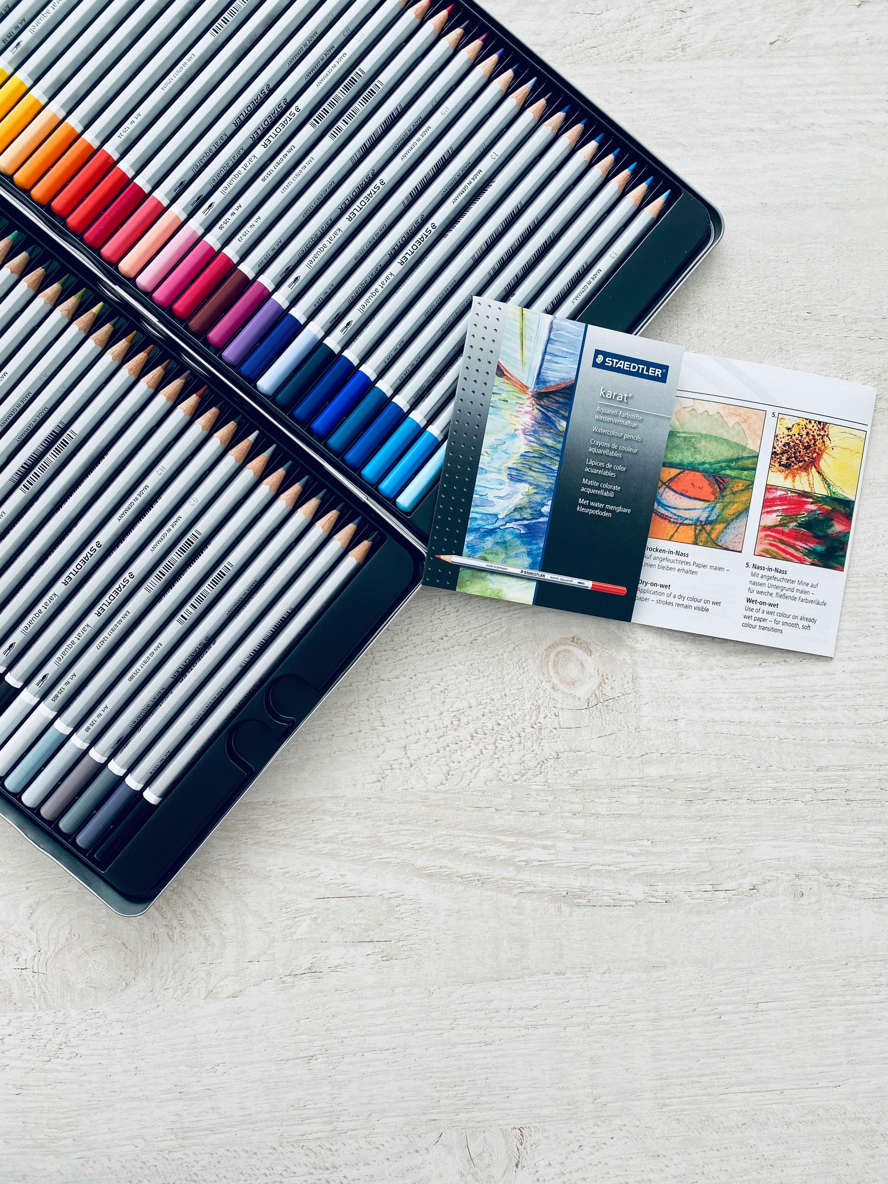 Colored Pencils and Pens on Wooden Surface · Free Stock Photo