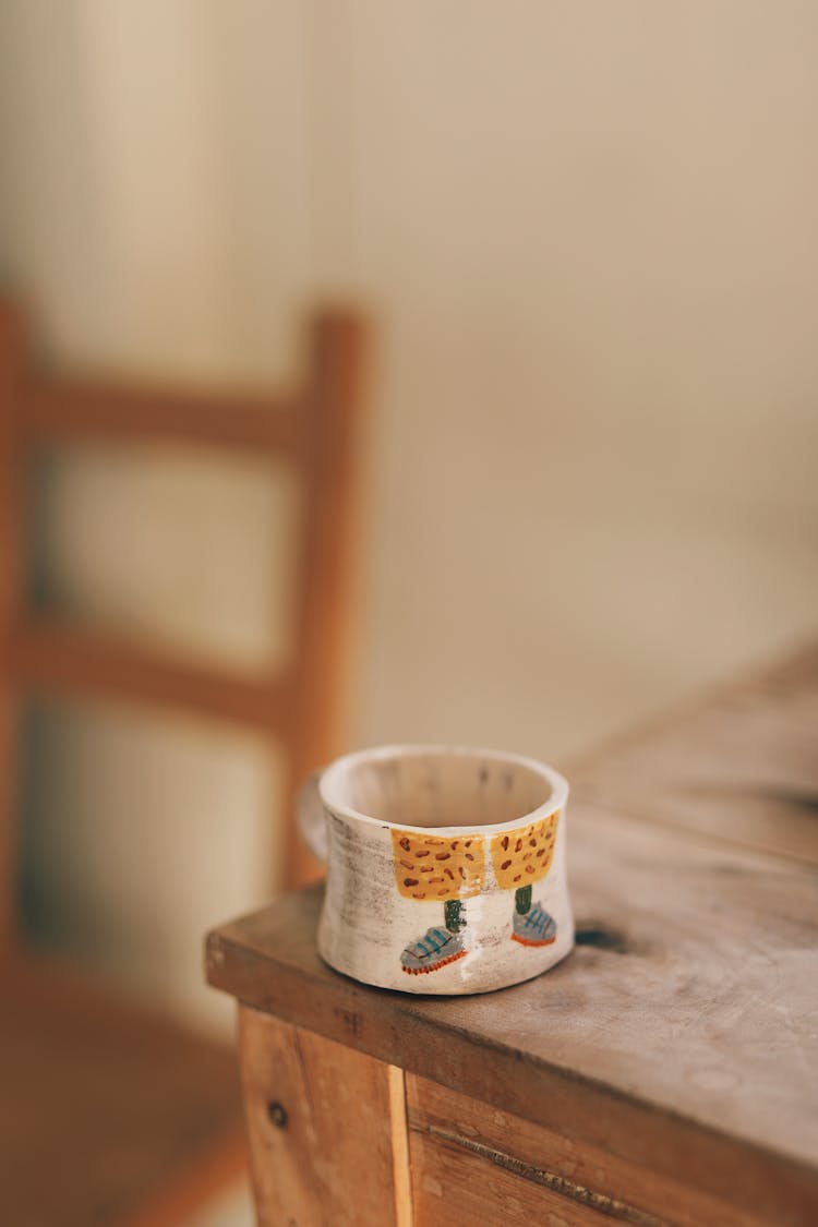 A Mug On The Edge Of A Table