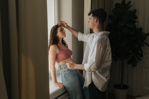 Free An Intimate Couple by the Window Stock Photo
