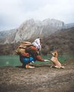 A Woman Shaking Hands with a Dog