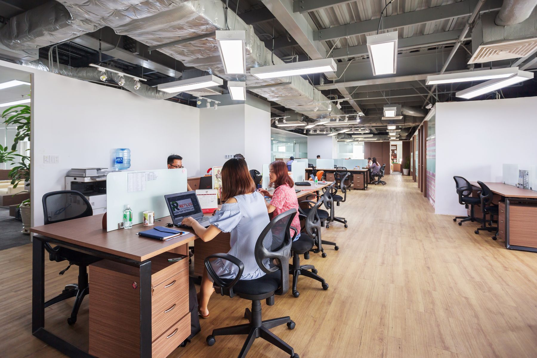 East Asian professionals collaborating in a contemporary office