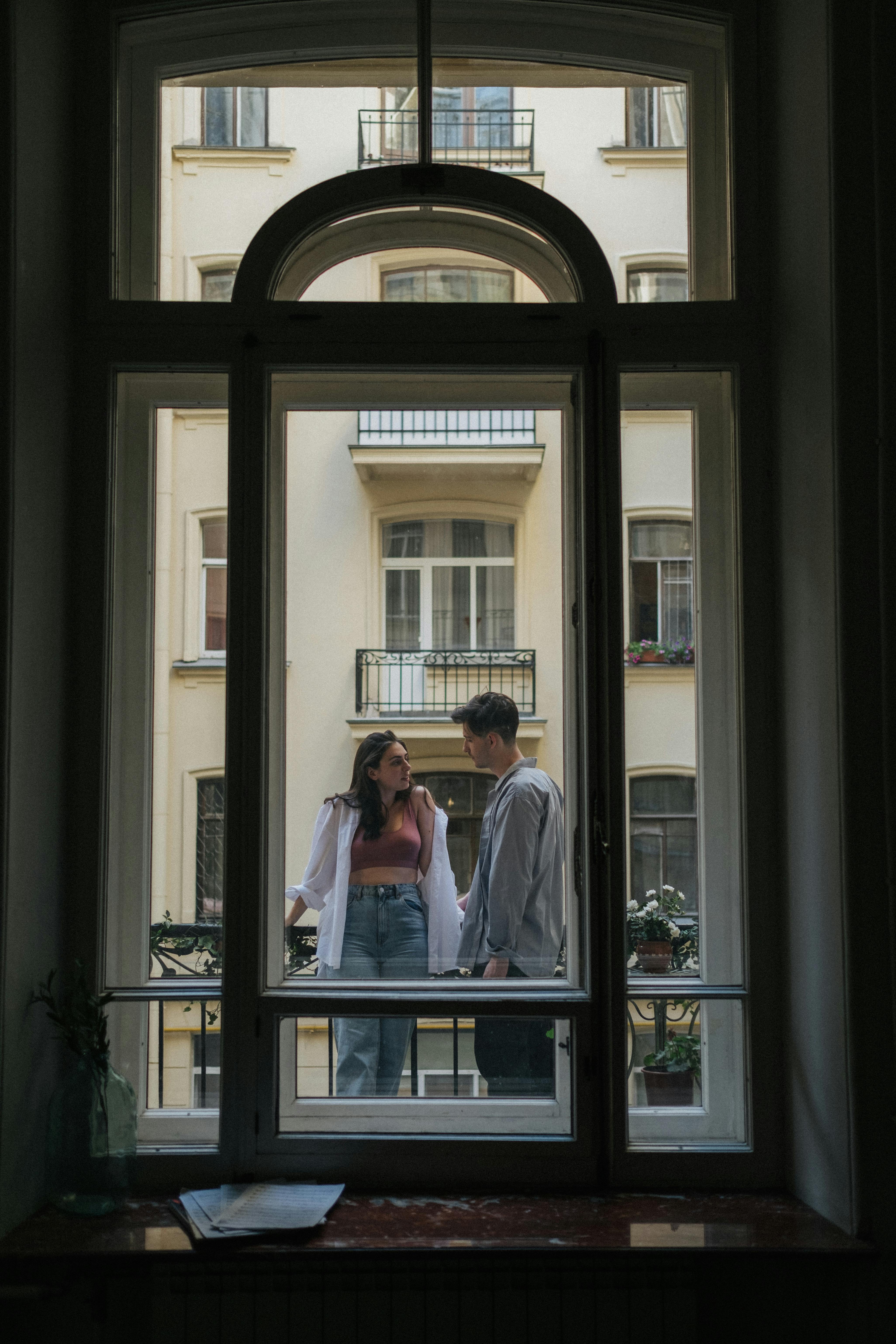 Man and Woman Standing on Balcony · Free Stock Photo