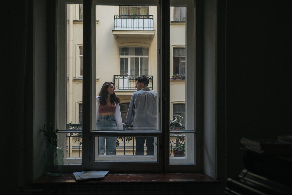 Man and Woman Standing in Front of Glass Window · Free Stock Photo