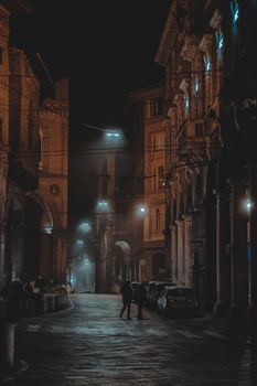 Explore the atmospheric charm of a dimly lit street surrounded by historic buildings at night.