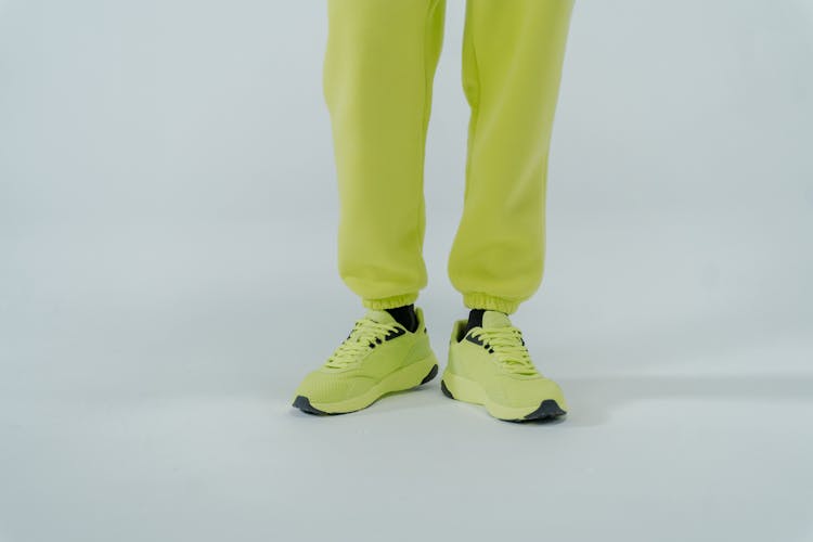 A Person In Neon Pants And Sneakers